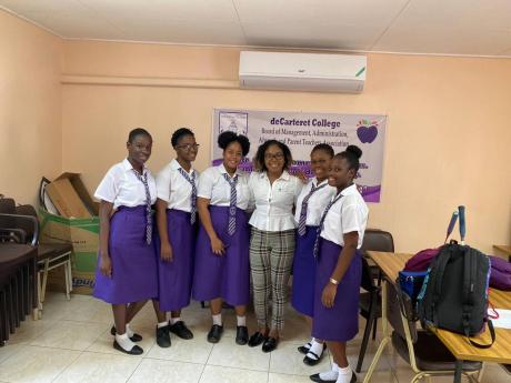 Monique Myers, founder and director of CanStudy Consulting, poses with the students of deCarteret College on a visit to the school during a recruitment drive. 