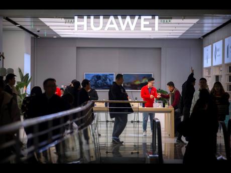 In this November 20 photo, customers shop at a Huawei store at a shopping mall in Beijing. 