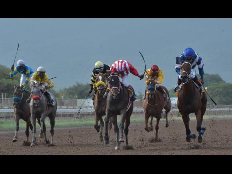 CRYPTOCURRENCY (centre), ridden by Ian Spence on his way to victory in the Titania Trophy over 1100m at Caymanas Park in St Catherine on Saturday, July 6, 2019.