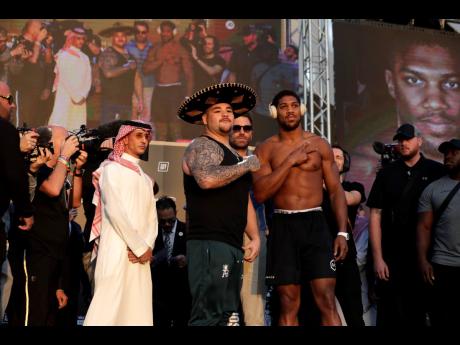 Heavyweight boxers Anthony Joshua of Britain (right) and Andy Ruiz Jr of Mexico pose during a weigh-in at Faisaliah Center, in Riyadh, Saudi Arabia, yesterday.