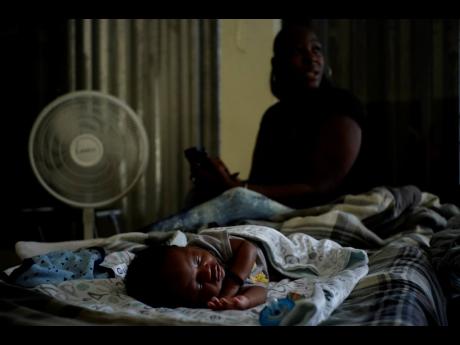 A baby sleeps inside a church that was opened up as a shelter for residents who will wait out Hurricane Dorian in Freeport on Grand Bahama, Bahamas, on September 1, 2019. Hurricane Dorian battered Bahamas with Category Five winds, killing at least 65 people and causing US$7 billion of damage. 