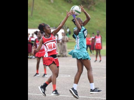 Shenae Melbourne (left) wing attack from Glenmuir High, tries to block a pass fromTamara Williams, goal defence from Denbigh High, during the ISSA Rural Area Schoolgirls Netball junior final on Thursday, December 5, 2019 at Manchester High School. Denbigh won 24-12.