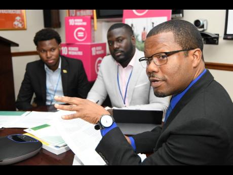 From left: Matthew McHayle, University of the West Indies student and Model UN delegate; Tijani Christian, Commonwealth Youth Council ambassador and development policy specialist; and UNDP Programmes Specialist Richard Kelly  at the global launch and unveiling of the 2019 Human Development Report in St Andrew yesterday.