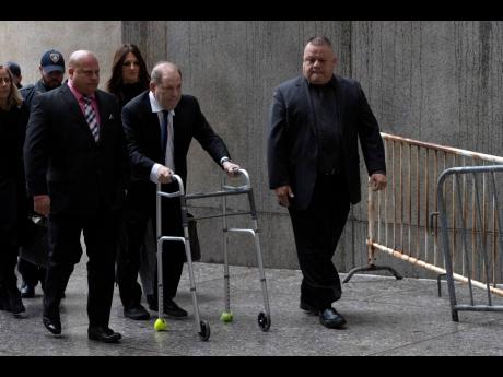 Harvey Weinstein (centre) arrives for a court hearing, yesterday in New York.