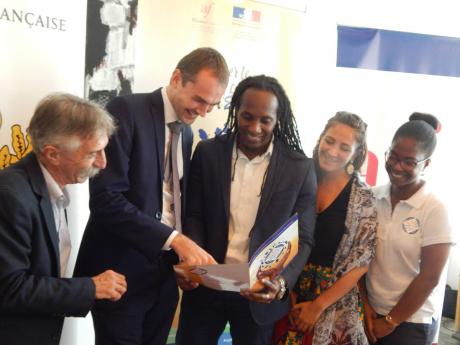Examining the project’s brochure are (from left) Pierre Lemaire, Laurent Gueslin, Alando Terrelonge, Sebrina Lipoff and Wendy Dyemma.
