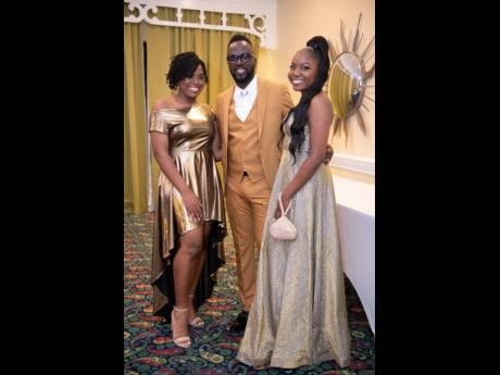 Nastasia Ellis (left) and Najali Ellis with their father, Ian ‘Ity’ Ellis, during a charity event, held at The Knutsford Court Hotel in New Kingston on December 6.