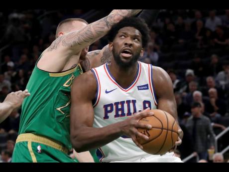 Philadelphia 76ers centre Joel Embiid looks for room to shoot against Boston Celtics forward Daniel Theis in the first quarter of an NBA basketball game on Thursday, Dec. 12, 2019, in Boston. The 76ers won 115-109.