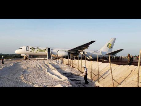 A Fly Jamaica Boeing 757-200 aircraft, which overshot the runway, sits at the northeastern take-off end of the runway at the Cheddi Jagan International Airport in Georgetown, Guyana, Friday, November 9, 2018. The airline filed for bankruptcy protection in October 2019.