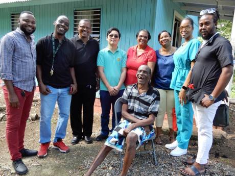 Echoing the joyful spirit of Christmas, Levy Neath (seated), aka ‘Shakey Bunny’, is captured here with We Believe Foundation members and the volunteers who took care of him on Saturday. From left: Philroy Facey, Prince Hall, Rev Devon Williams, Dr Pyae Sone Phyo, Doreen Crowther, beautician Juliet Beam, nurse Toni-Ann Newland and Tommy, the barber.