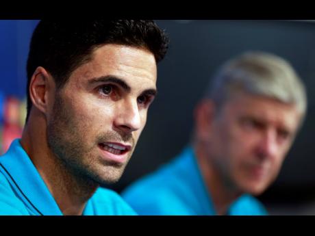 In this Tuesday, September  15, 2015 file photo, Arsenal’s Mikel Arteta (left) attends a news conference in Zagreb, Croatia. Arsenal hired Mikel Arteta as manager on Friday, December 20, 2019, hoping their former midfielder can turn around the fortunes of the ailing London club after spending more than three years learning the coaching ropes as assistant to Pep Guardiola at English champion Manchester City 