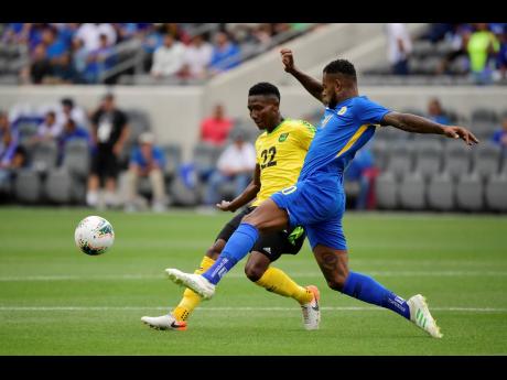 Jamaica midfielder Devon Williams (left) and Curacao midfielder Leandro Bacuna compete for the ball during the first half of a Concacaf Gold Cup match in Los Angeles, California, on Tuesday, June 25, 2019.