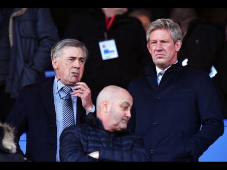 Everton’s new manager Carlo Ancelotti (left) and director of football Marcel Brands in the stands during the English Premier League match between Everton and Arsenal at Goodison Park, Liverpool, England, yesterday. The match ended 0-0.