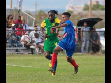 Vere United’s Devroy Grey (left) and Portmore United’s Lamar Walker in a foot race during their Red Stripe Premier League match recently.