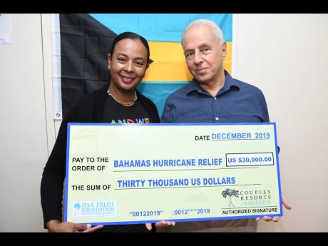 Paul Issa, chairman of Issa Trust Foundation presents a cheque valued at US$30,000 to Alveta Knight, Honorary Consul, The Bahamas, at the consulate on Old Hope Road, St Andrew last week Friday.