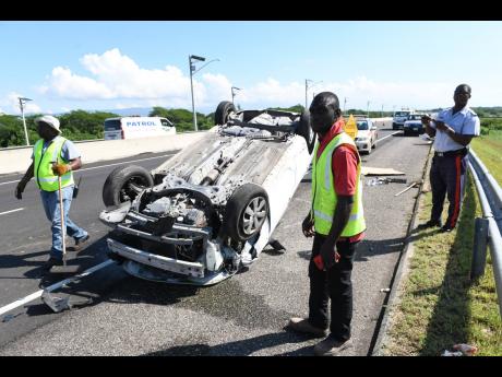 Highway 2000 staff and police on the scene of a motor vehicle accident on the East-West Highway near the Spanish Town  toll plaza in St Catherine in November. The driver and passengers were taken to hospital.