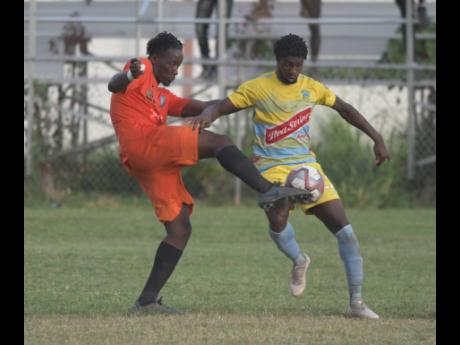 
Tivoli Gardens’ Jabeur Johnson (left) tackles Waterhouse player Colorado Murray  in their  Red Stripe Premier League encounter at the Edward Seaga Sports Complex recently.