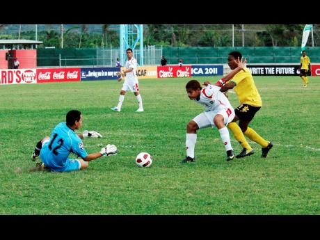 Panama’s goalkeeper Ivan Picart (left) collects the ball safely during a Jamaican attack, while his teammate and skipper Roberto Chen keeps Jamaica’s Jevani Brown at bay during action from the 2011 CONCACAF Under-17 third-place play-off between the two teams at the Montego Bay Stadium in 
St James. Panama won the game 1-0.