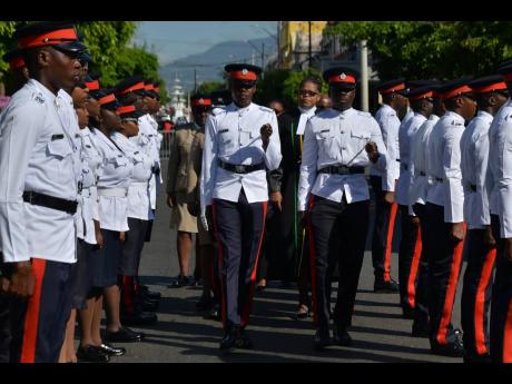 Puisne judge, Justice Georgiana Fraser, inspecting a guard of honour in front of the Supreme Court on King Street, downtown Kingston, yesterday. The occasion was the opening ceremony of the Hilary term for the Home Circuit Court.