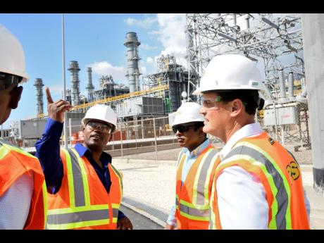 Noel Watson (left), plant manager; Mo Majeed (centre), chairman of South Jamaica Power Centre’s Management Committee; and Emanuel DaRosa, president and CEO of JPS, participate in a media tour of the 194MW power plant in Old Harbour, St Catherine, on Thursday.