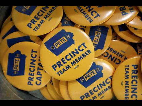 In this January 9, 2020 file photo, precinct team member buttons are seen during a caucus training meeting at the local headquarters for Democratic presidential candidate and former South Bend, Indiana, Mayor Pete Buttigieg, in Ottumwa, 
Iowa. 