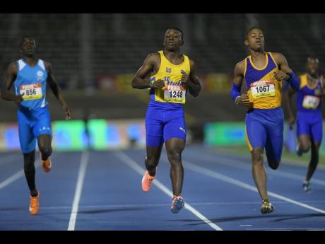 Lacovia High’s Brian Roach (left) placing third in his heat of the Class Two 200m at the 2018 Boys and Girls’ Championships. The heat was won by Sachin Dennis (centre) of St Elizabeth Technical while Justin Emmanuel (right) of Papine High was third. 
