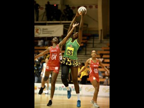 England’s goalkeeper Ama Agbeze (left) tries to intercept a pass to Jamaica’s Jhaniele Fowler (centre), while goal defence Layla Guscoth looks on during the third and final Lasco Sunshine Series game between Jamaica and England at the National Indoor Sports Centre on October 15, 2018. FILE