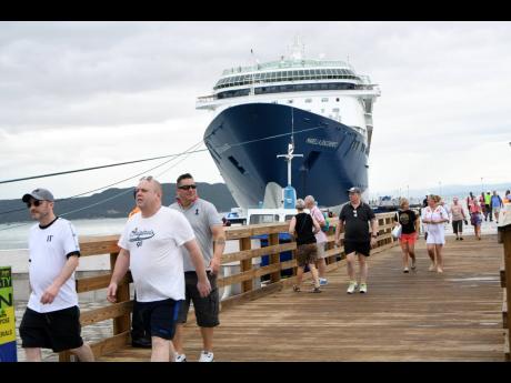 Tourists mill about at the Port Royal Cruise Ship Pier after the Marella Discovery 2 docked at the east Kingston town on Monday.