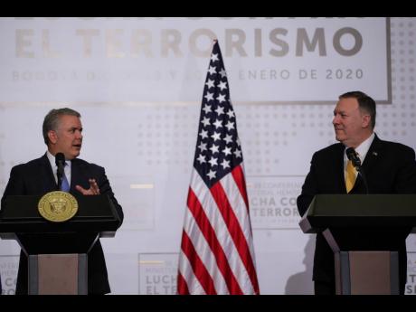 Colombian President Ivan Duque (left) and US Secretary of State Mike Pompeo open a regional counter-terrorism meeting at the police academy in Bogota on Monday. Pompeo is expected to arrive in Jamaica this evening for a two-day working visit.