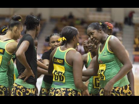 Members of Jamaica's senior netball team huddle during a match against England at the National Indoor Sports Centre in Kingston on Saturday, October 13, 2018.