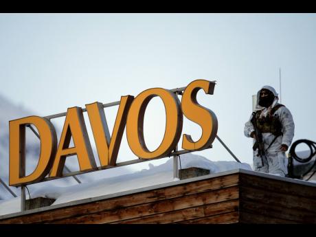 AP 
A police security guard patrols on the roof of a hotel ahead of the World Economic Forum in Davos, Switzerland, on Monday, January 20.  The United States, United Kingdom and European Union are looking to make progress on trade deals this year.