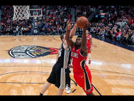 New Orleans Pelicans forward Zion Williamson (right) goes to the basket against San Antonio Spurs centre Jakob Poeltl in the second half of their NBA game in New Orleans, Louisiana, on Wednesday.