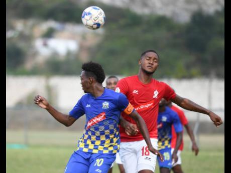Molynes United's Nicholas Nelson (left) goes up for a header with UWI's Sheldon McKoy in their Red Stripe Premier League encounter at the UWI Mona Bowl on Sunday, January 26, 2020.
