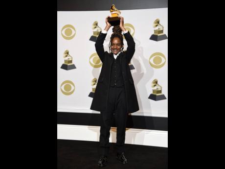 Koffee raises aloft the award for Best Reggae Album for ‘Rapture’ at the 62nd annual Grammy Awards at the Staples Center in Los Angeles on Sunday. 