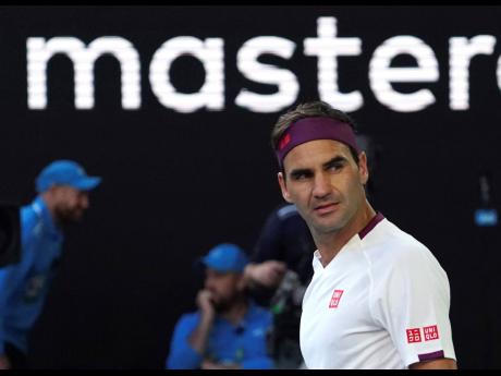 Switzerland’s Roger Federer reacts after defeating Tennys Sandgren of the US in their quarter-final match at the Australian Open tennis championships in Melbourne yesterday.