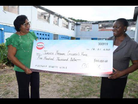 Dianna Blake-Bennett (left), general manager of Salada Foods Jamaica, presents a symbolic cheque of $500,000 to Nadeen Waugh, director of Jamaica National Children’s Home, recently.