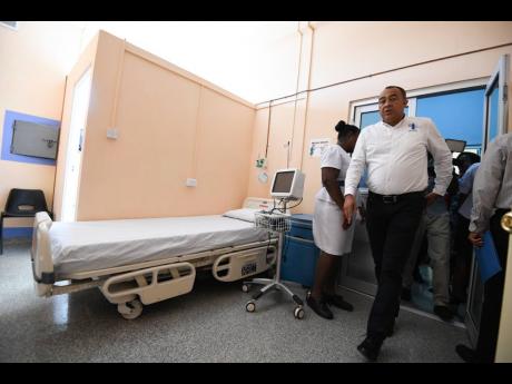 Health and Wellness Minister Dr Christopher Tufton examines an isolation room at the National Chest Hospital in St Andrew on Thursday. Tufton and technocrats from the ministry  toured locations for quarantine at the National Chest Hospital and the Norman Manley International Airport, where he indicated he was satisfied with what he saw as part of Jamaica’s preparations in the event the deadly coronavirus enters the country.