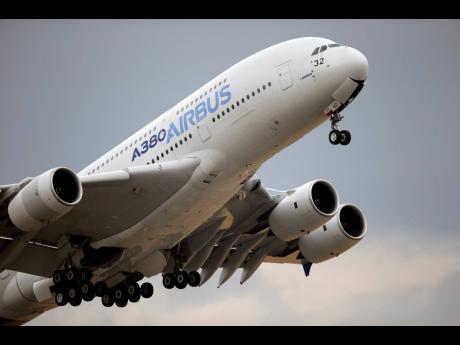 In this June 18, 2015 file photo, an Airbus A380 takes off for its demonstration flight at the Paris Air Show in Le Bourget airport, north of Paris. 