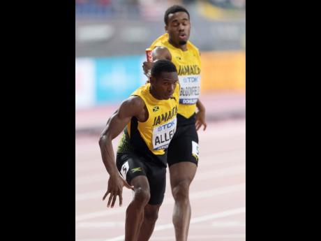 Akeem Bloomfield (right) hands off the baton to Nathon Allen in the men’s 4x400m semi-final at last year’s World Athletics Championships in Doha, Qatar. 