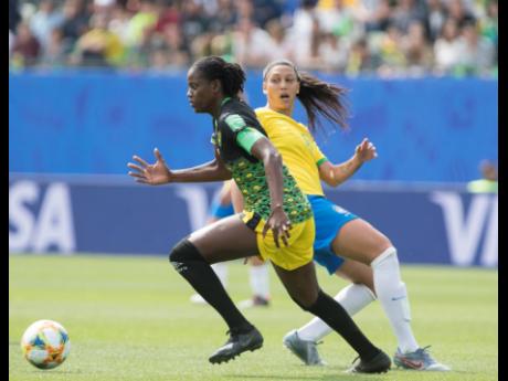 File
Reggae Girl Konya Plummer (left) was forced off the field by an injury early in the second half.