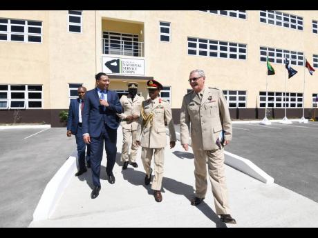 Prime Minister Andrew Holness (left) with Lieutenant General Rocky Meade (second right), chief of defence staff,  and Lieutenant Colonel Blair Waddington (right), executive officer, Caribbean Military Academy, at yesterday’s opening ceremony for the Jamaica National Service Corps multipurpose building at Up Park Camp.