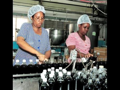 Workers bottle Benjamins products on the factory floor at P.A. Benjamin Manufacturing Company in Kingston in this 2010 file photo. The company expects to commission new operating space in April 2020 as it positions to grow exports.
