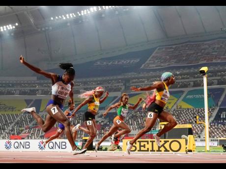 Shelly-Ann Fraser-Pryce (right) of Jamaica finishes ahead of Dina Asher-Smith (left) of Britain and Marie-Josée Ta Lou (second right) of the Ivory Coast in the women’s 100m final at the World Athletics Championships in Doha, Qatar, last September 29, 2019. Also pictured is Jamaica’s Elaine Thompson Herah.