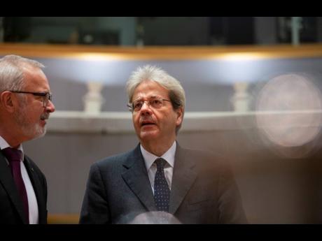 European Commissioner for Economy Paolo Gentiloni, right, speaks with President of the European Investment Bank Werner Hoyer during a meeting of EU finance ministers at the Europa building in Brussels, Tuesday, February 18, 2020.