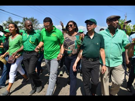 Pearnel Charles Jr (second left) and wife Eleasia (left) march hand in hand with (from third left) Jamaica Labour Party leader Andrew Holness, St Andrew East Rural MP Juliet Holness, JLP General Secretary Dr Horace Chang, and former Clarendon South East MP Rudyard Spencer. They participated in the nomination of Charles last Wednesday for the March 2 by-election.