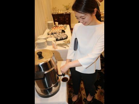 A member of the  All Japan Coffee Roasters Association prepares to enjoy a cup of frewly brewed Blue Mountain Coffee at a reception hosted by the Japanese Embassy for the group during their Jamaica 2020 tour which ran from February 16-20.