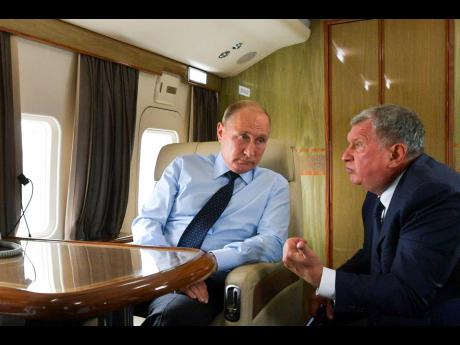 AP 
In this August 27, 2018 file photo, Russian President Vladimir Putin (left) listens to Russian Rosneft CEO Igor Sechin during his flight to visit Chernigovets coal mine in Beryozovsky, Kemerovo region, Russia.