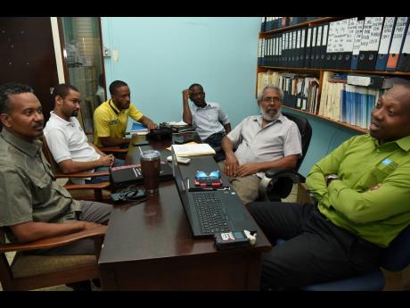 Ian Allen/Photographer 
Participants in a castor oil meeting held February 13, 2020 at the Jamaica Manufacturers and Exporters Association, JMEA, secretariat at Duke Street Kingston, from left: Industry members Fitzroy Ferguson and Joel Harris and JMEA administrative assistant Orlando Johnson, industry member Paul Wilson, Castor Oil Association of Jamaica president Courtney Haughton, and Niconor Reece of the Petroleum Corporation of Jamaica.