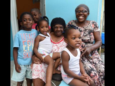 Martina Symister (centre), 102, poses with her daughter, Dahlia Symister (right), and great-grandchildren. From left are Kevani Shakes, Kewyane Shakes, Reniela Rowe, and Kaylee Davis.