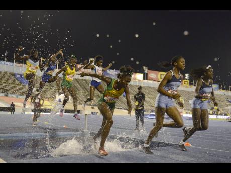 Edwin Allen High’s Kayan Green (second right) competing in the 2000 metres steeplechase open at the 2017 ISSA/GraceKennedy Boys and Girls’ Championships. Green’s teammate Jeima Davis is at right while at left is Jameaka Manning of St Jago. 
