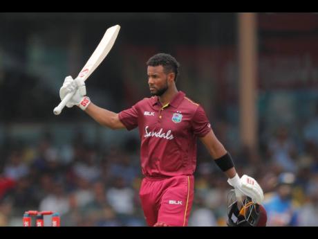 
West Indies’ Shai Hope raises his bat after scoring a century against Sri Lanka during their first one-day international cricket match in Colombo, Sri Lanka, yesterday.